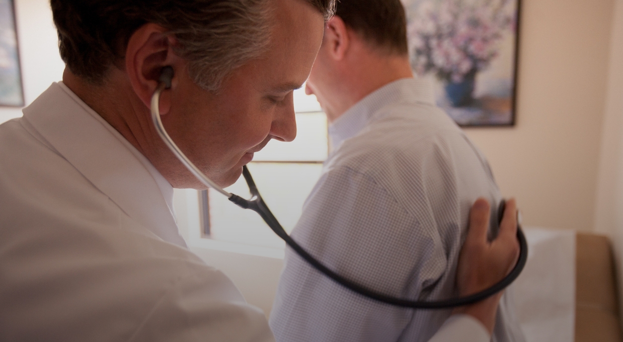 Doctor checking patient with stethoscope during wellness checkup