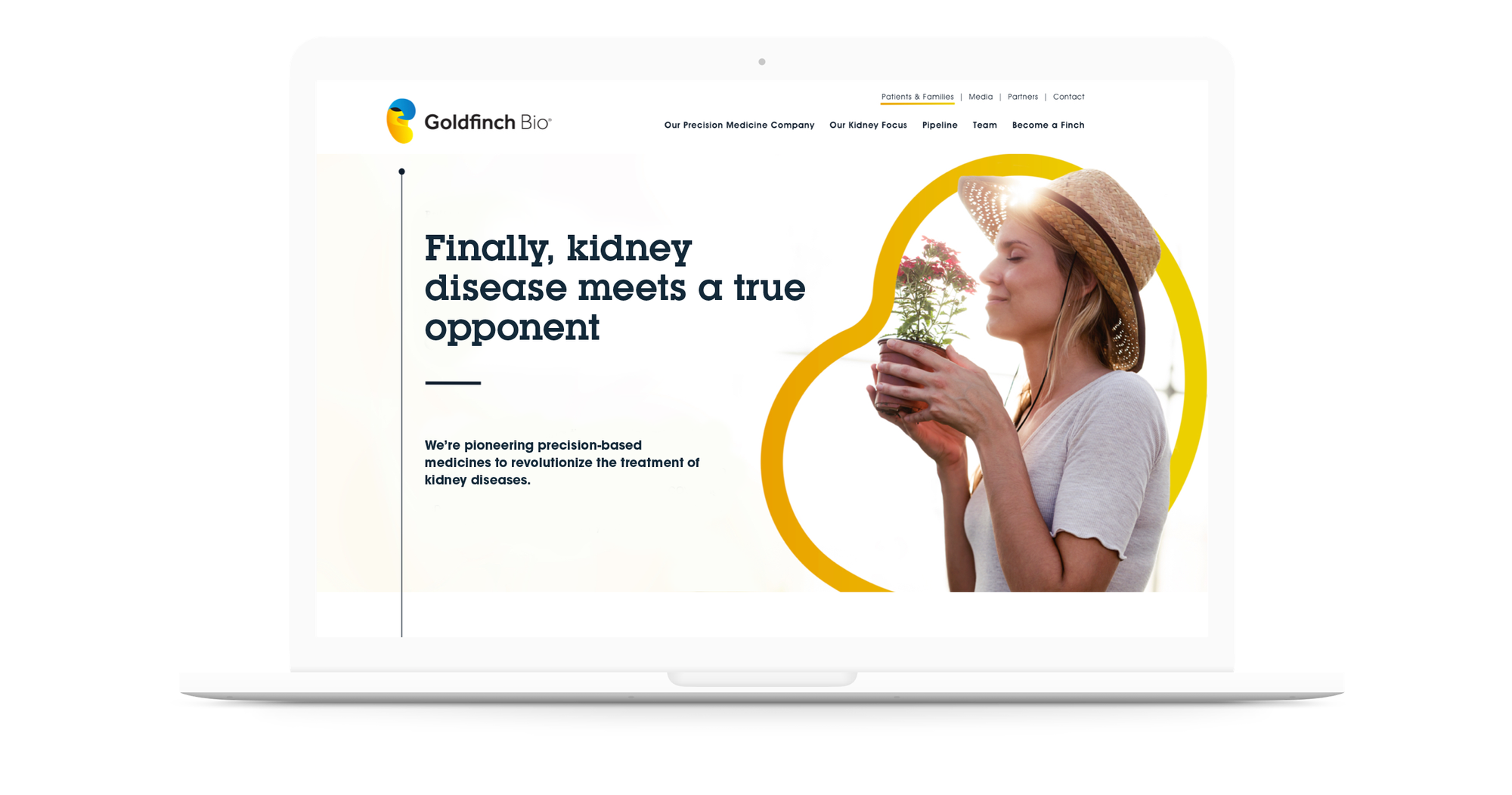 Goldfinch website mock up on laptop computer, woman smelling potted flowers in sunhat